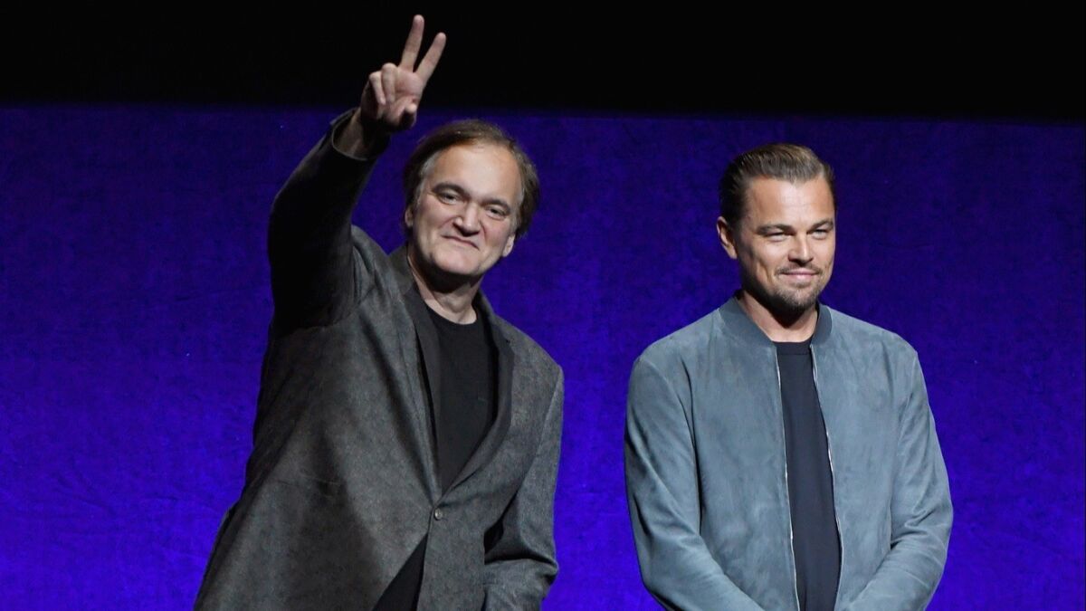 Quentin Tarantino, left, and Leonardo DiCaprio surprised movie theater owners at CinemaCon on Monday.