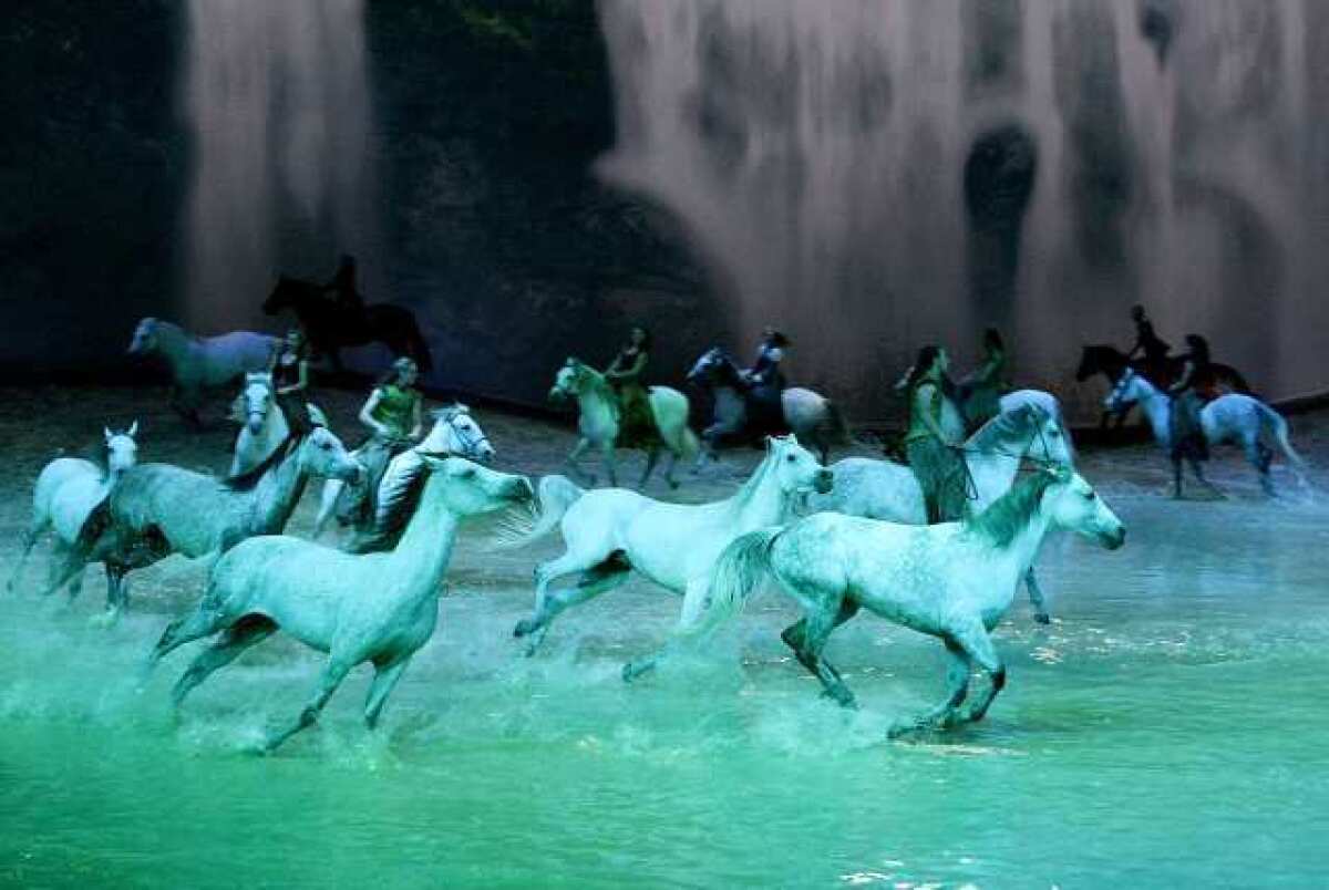 ARCHIVE PHOTO: White horses race around a large pool of water during the Cavalia Odysseo show in Burbank.
