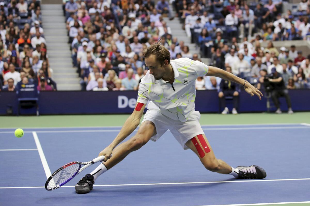 Daniil Medvedev lunges to return a shot to Rafael Nadal during the men's singles final of the U.S. Open on Sunday.
