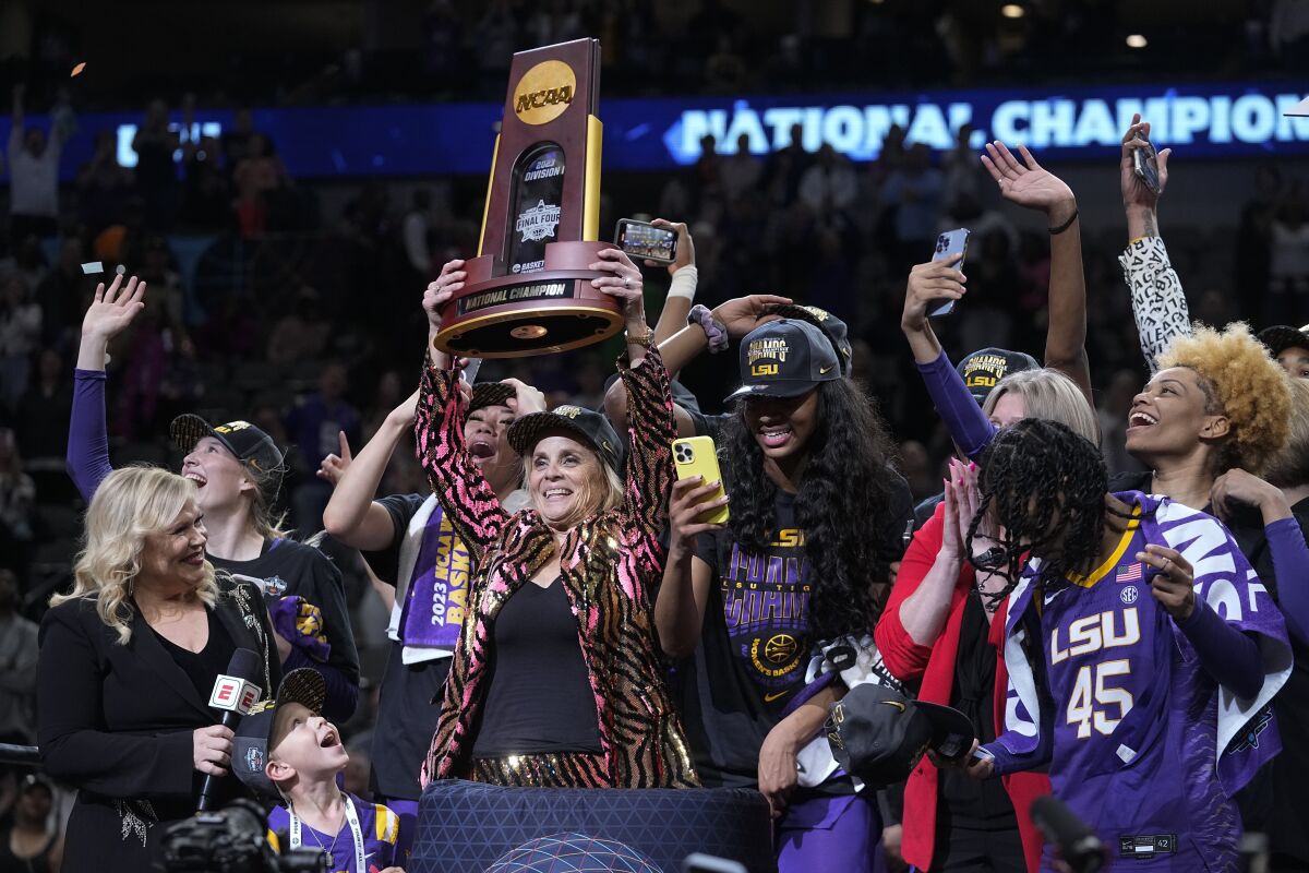 LSU head coach Kim Mulkey and players celebrate after the NCAA Women's Final Four championship basketball game against Iowa Sunday, April 2, 2023, in Dallas. LSU won 102-85 to win the championship. (AP Photo/Darron Cummings)