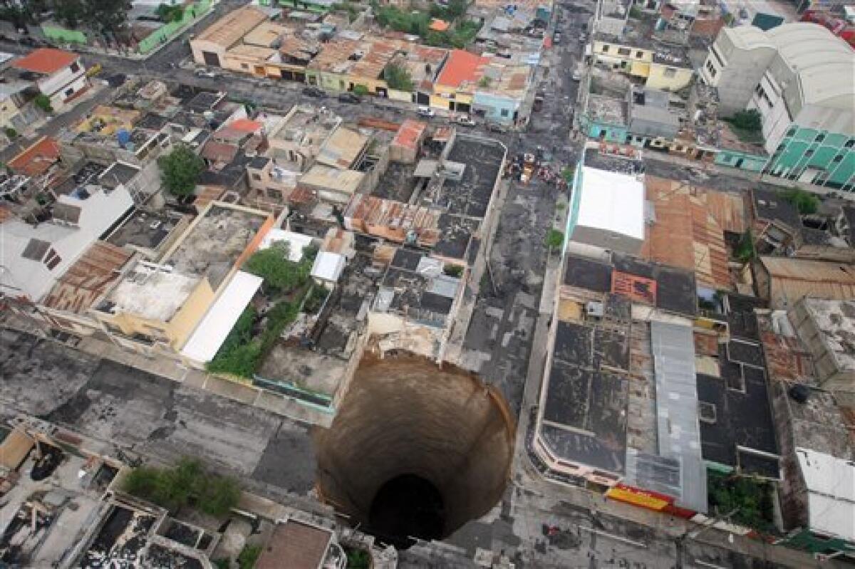 In this photo released by Guatemala's Presidency on Monday May 31, 2010, a sinkhole covers a street intersection in downtown Guatemala City, Monday May 31, 2010. A day earlier authorities blamed the heavy rains caused by tropical storm Agatha as the cause of the crater that swallowed a a three-story building but now say they will be conducting further studies to determine the cause. Last April 2007, another giant sinkhole in the same area killed 3 people.(AP Photo/Guatemala's Presidency, Luis Echeverria)