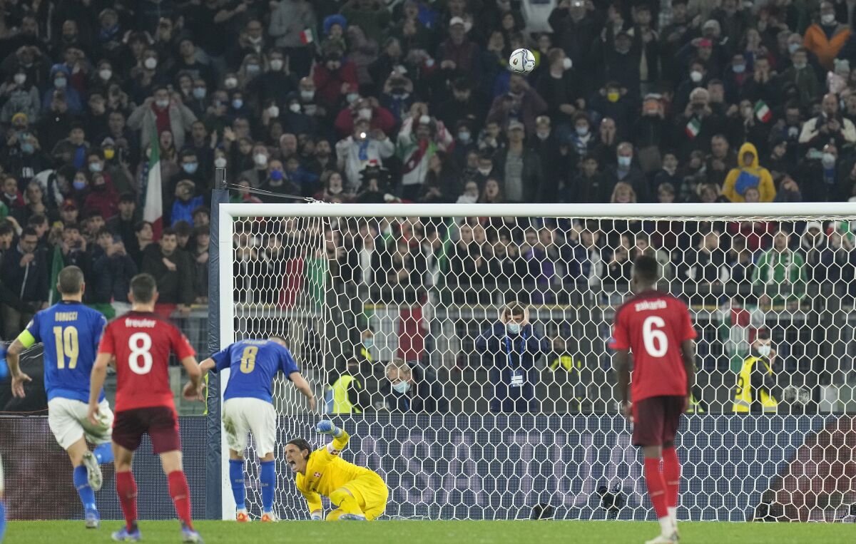 Switzerland goalkeeper Yann Sommer celebrates after Italy's Jorginho, third left, blasted the ball over the bar to miss a penalty during the World Cup 2022 group C qualifying soccer match between Italy and Switzerland at Rome's Olympic stadium, Friday, Nov. 12, 2021. (AP Photo/Gregorio Borgia)