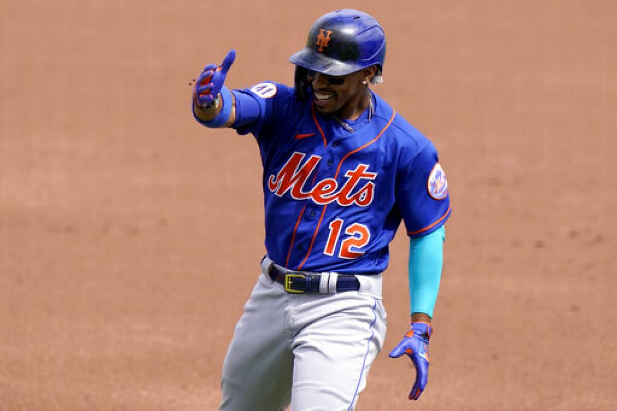 New York Mets' Francisco Lindor (12) reacts after flying out to Washington Nationals center fielder Victor Robles during the first inning of a spring training baseball game, Monday, March 8, 2021, in West Palm Beach, Fla. (AP Photo/Lynne Sladky)