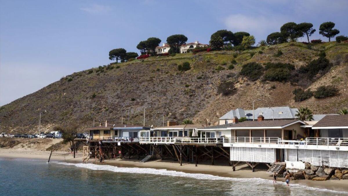 The hilltop mansion seen from the Malibu shore.