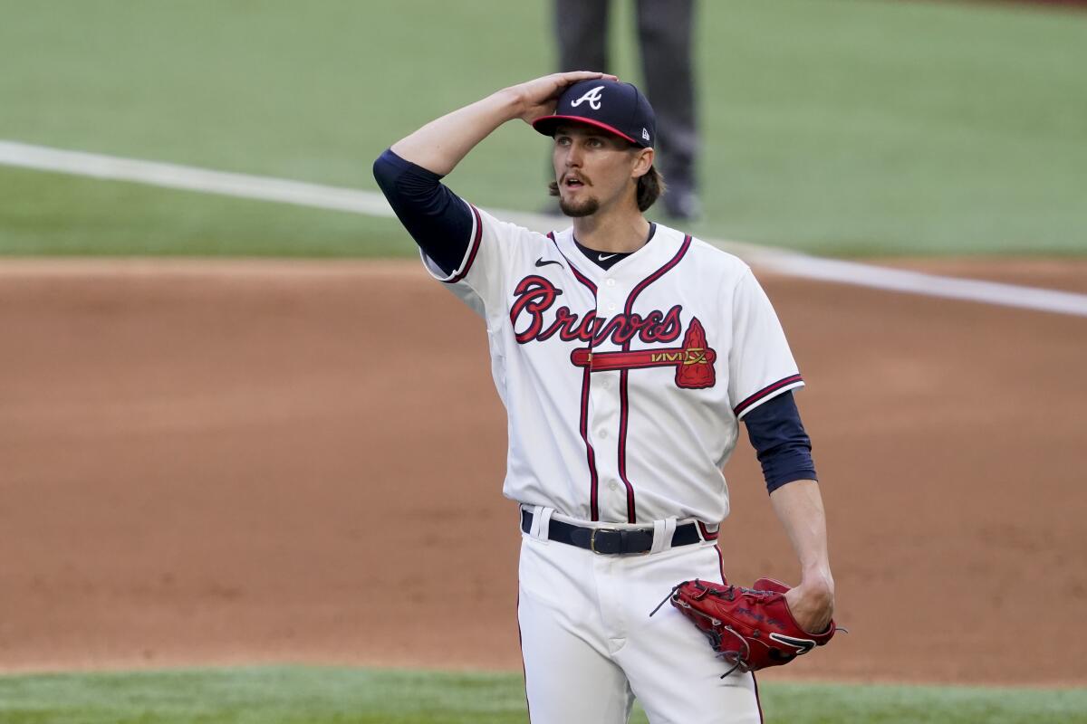 Atlanta Braves starting pitcher Kyle Wright reacts after giving up a three-run home run to Joc Pederson.