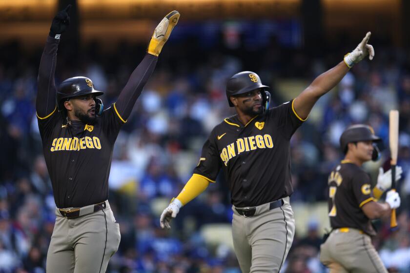 LOS ANGELES, CALIFORNIA - APRIL 14: Fernando Tatis Jr. #23, Xander Bogaerts #2, and Eguy Rosario #5 of the San Diego Padres celebrate a three run double from Jurickson Profar #10, to take a 6-3 lead over the Los Angeles Dodgers, during the seventh inning at Dodger Stadium on April 14, 2024 in Los Angeles, California. (Photo by Harry How/Getty Images)