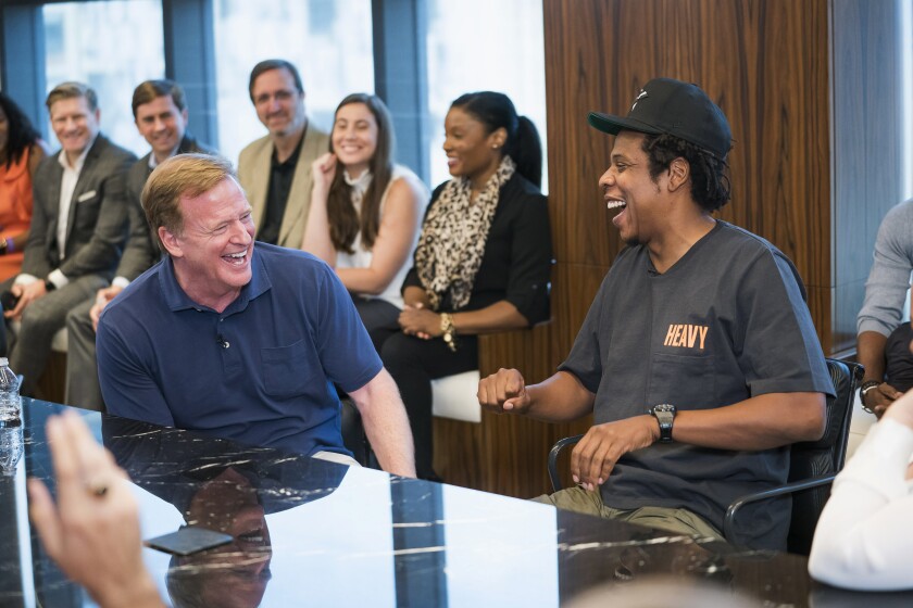 NFL Commissioner Roger Goodell, left, and Jay-Z laugh during a news conference at ROC Nation in New York on Wednesday.