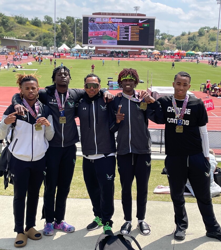 Upland hurdlers, from left, DeQuan January Jr., Delaney Crawford, coach Day Lyric, Kai Graves-Blanks and Davis Davis-Lyric.