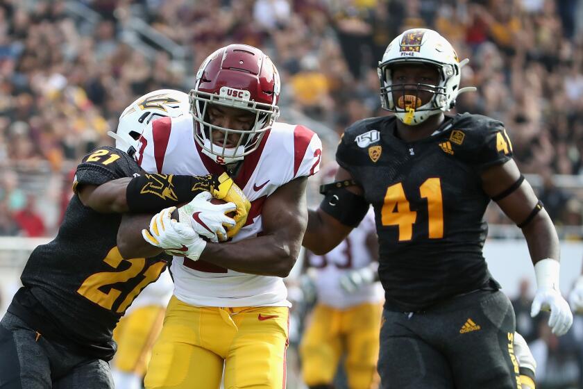 TEMPE, ARIZONA - NOVEMBER 09: Running back Kenan Christon #23 of the USC Trojans runs with the football en route to scoring on a 58 yard touchdown reception ahead of defensive back Jack Jones #21 and defensive lineman Tyler Johnson #41 of the Arizona State Sun Devils during the first half of the NCAAF game at Sun Devil Stadium on November 09, 2019 in Tempe, Arizona. The Trojans defeated the Sun Devils 31-26. (Photo by Christian Petersen/Getty Images) ** OUTS - ELSENT, FPG, CM - OUTS * NM, PH, VA if sourced by CT, LA or MoD **