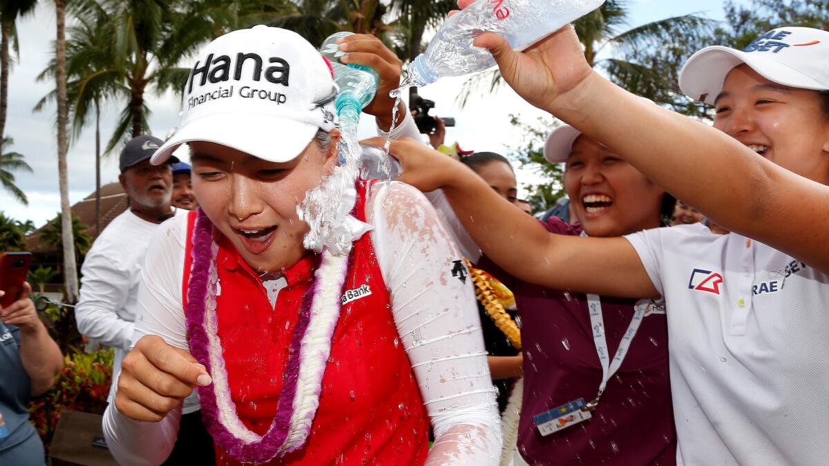 Minjee Lee gets a soaking from Haru Nomura, center, and Sei Young Kim after winning the Lotte Championship on Saturday.