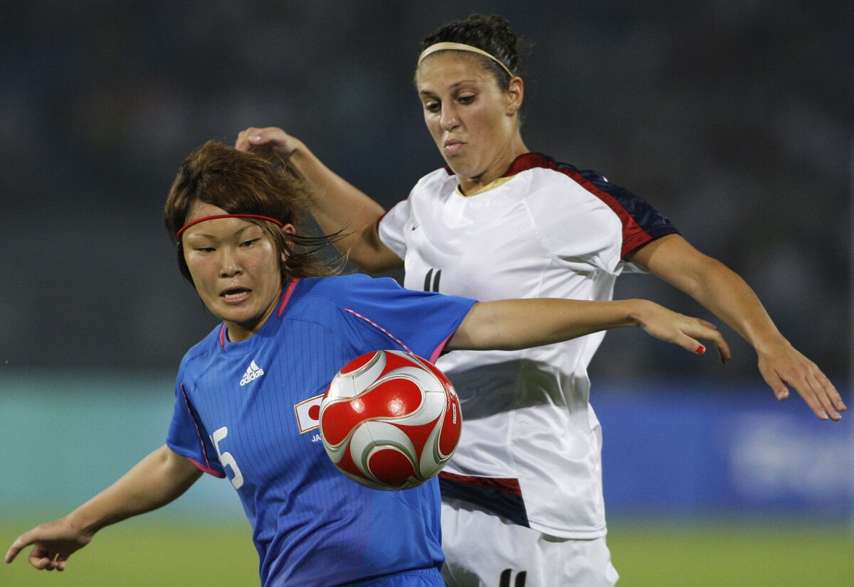 FILE - In this Aug. 18, 2008, file photo, Carli Lloyd, right, of the U.S., vies for the ball with Mizuho Sakaguchi, of Japan