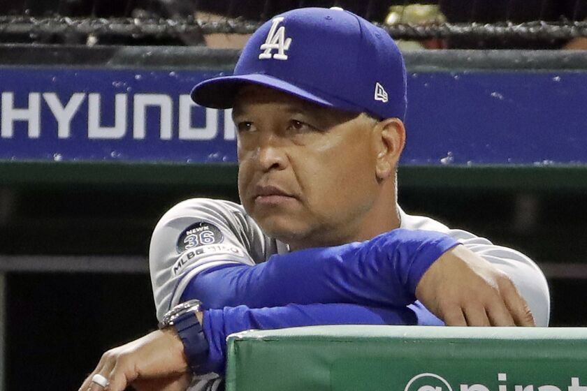 Los Angeles Dodgers manager Dave Roberts watches from the dugout steps during the sixth inning of a baseball game against the Pittsburgh Pirates in Pittsburgh, Saturday, May 25, 2019. (AP Photo/Gene J. Puskar)