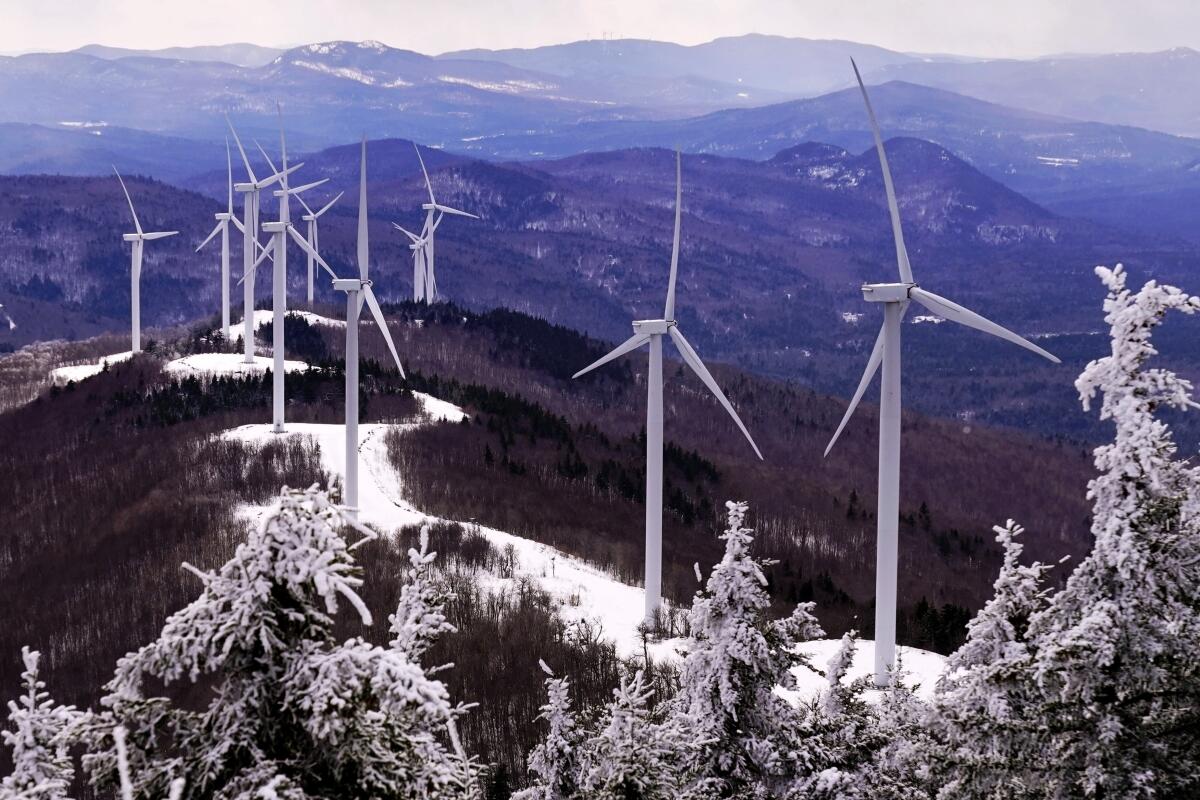 Wind turbines face into the breeze on top of Saddleback Wind Mountain, Saturday, Feb. 6, 2021, in Carthage, Maine. President Joe Biden wants to change the way the U.S. uses energy by expanding renewables, but faces several challenges. (AP Photo/Robert F. Bukaty)