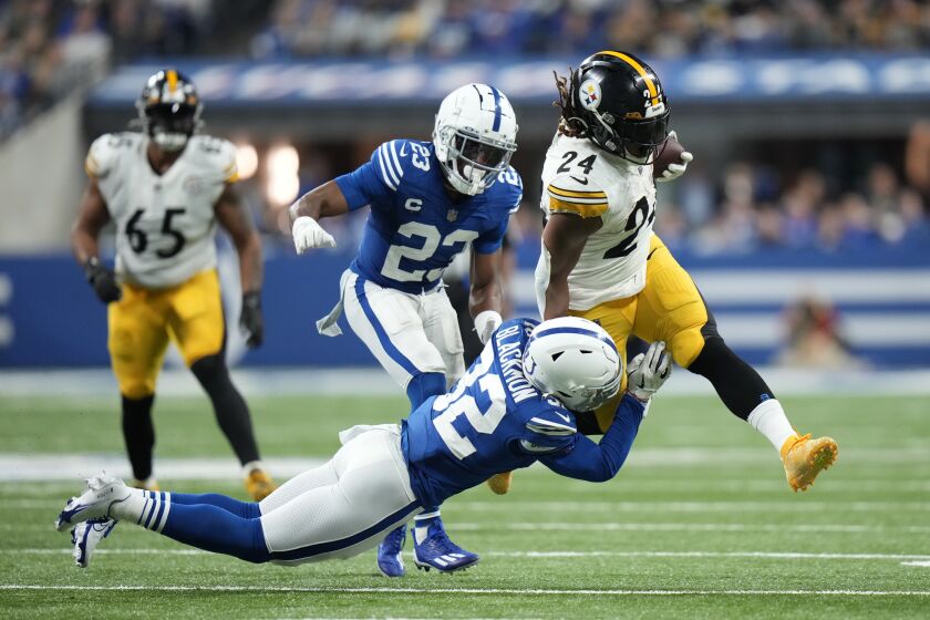 Pittsburgh Steelers' Benny Snell Jr. (24) is tackled by Indianapolis Colts' Julian Blackmon (32) during the second half of an NFL football game, Monday, Nov. 28, 2022, in Indianapolis. (AP Photo/AJ Mast)