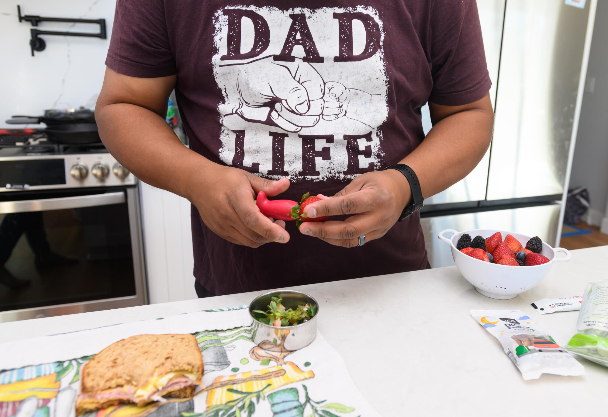 Mario Martinez prepares snacks at a kitchen counter