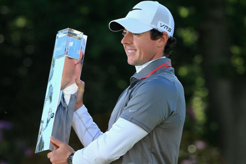Rory McIlroy poses with the trophy following his victory at the BMW PGA Championship on Sunday.