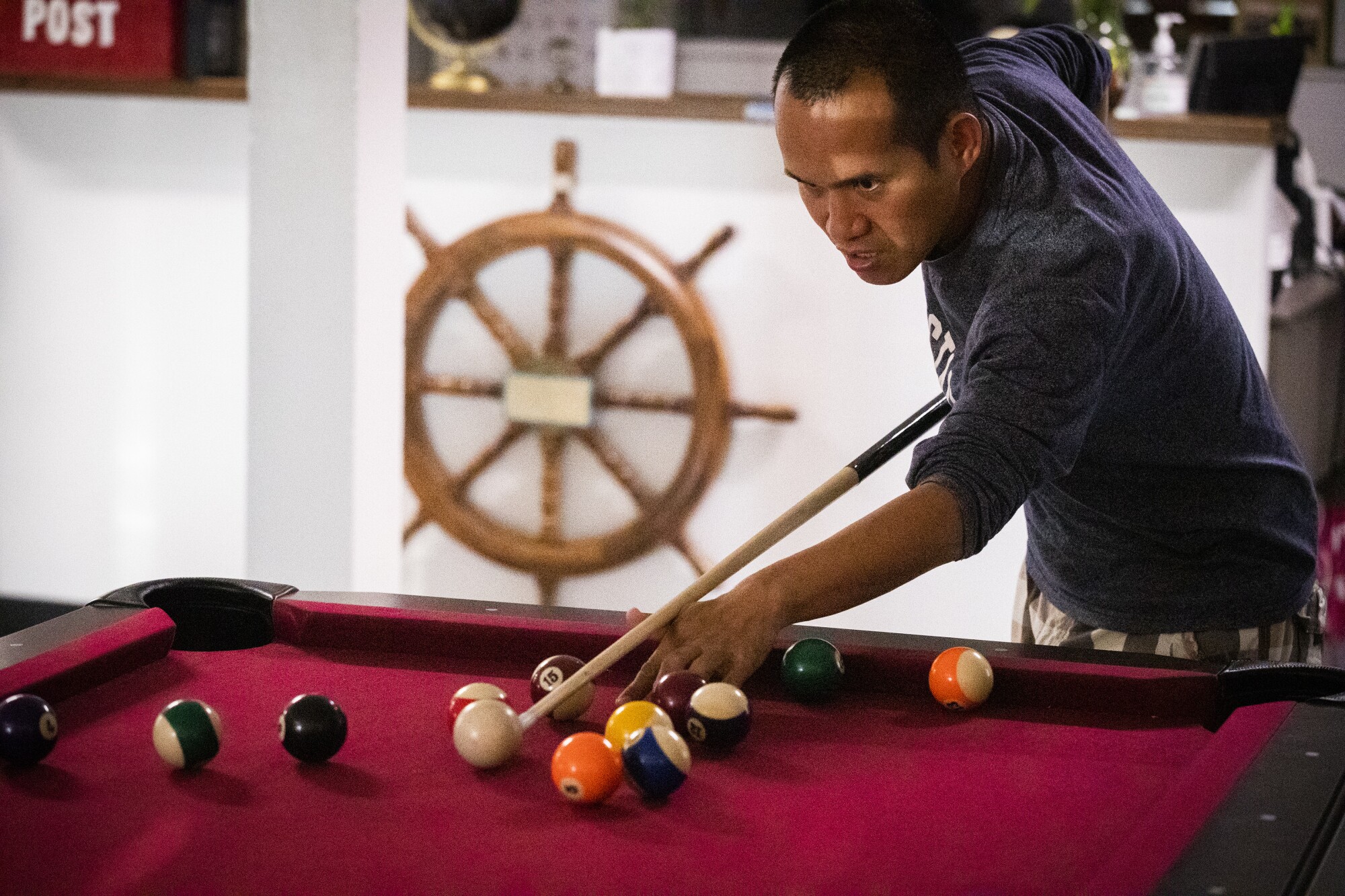 Rudy Cesar, of Lancaster, plays pool at the International Seafarers Center