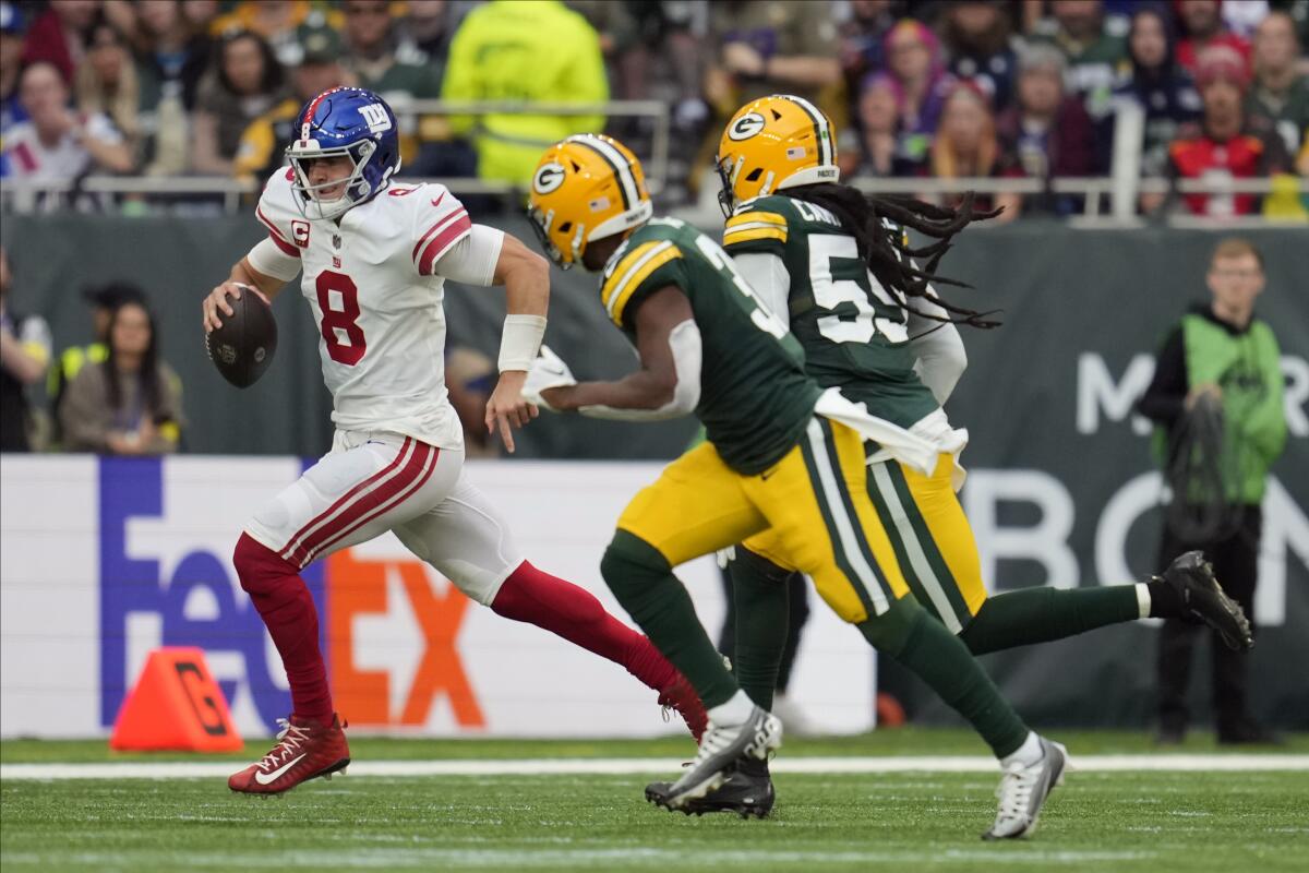 New York Giants quarterback Daniel Jones (8) scrambles during the second half of an NFL football game against the Green Bay Packers at the Tottenham Hotspur stadium in London, Sunday, Oct. 9, 2022. (AP Photo/Kin Cheung)