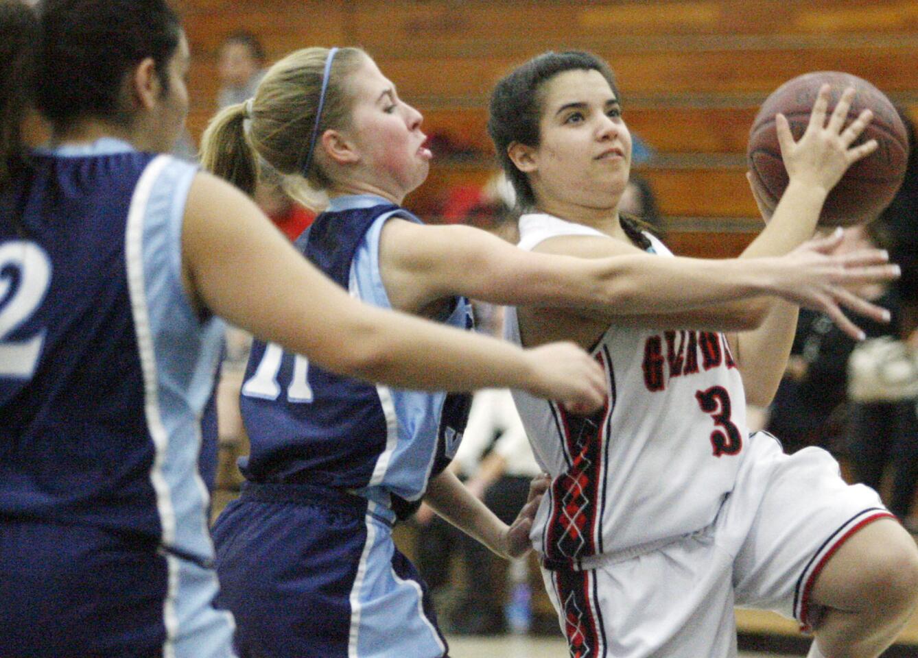 Glendale's Amanda Mazanians, right, goes for a shot while CV's Jacqueline Wilson defends Mazanians during a game at Glendale High School l in Glendale on Tuesday, January 22, 2013.