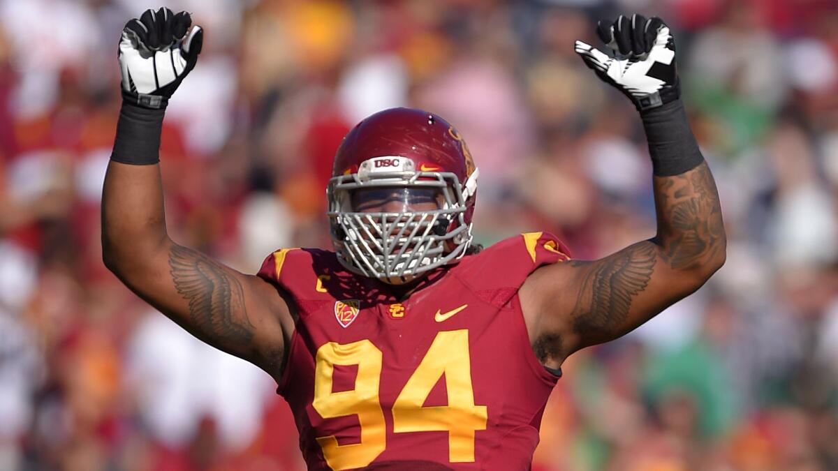 USC defensive end Leonard Williams gestures to fans during the Trojans' 49-14 win over Notre Dame at the Coliseum on Saturday.