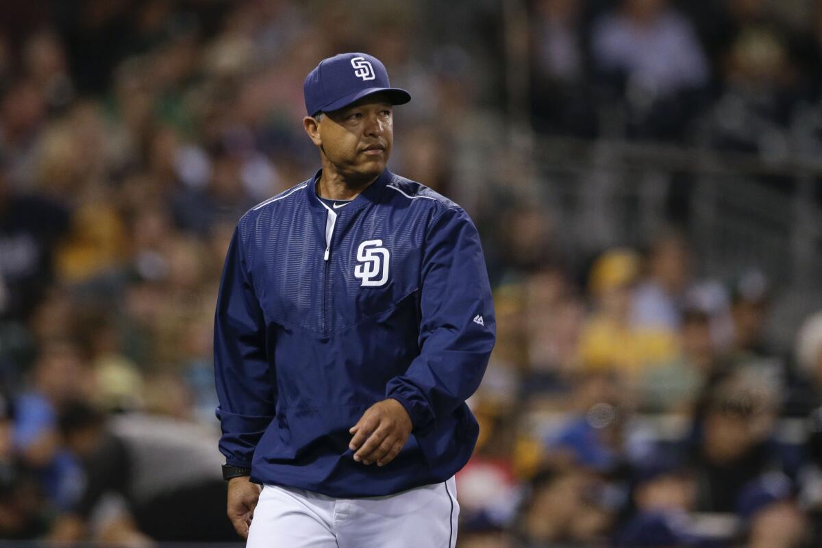 Dave Roberts, acting Padres manager for one game agianst the Oakland A's on June 15, heads to the dugout after a visit to the mound.