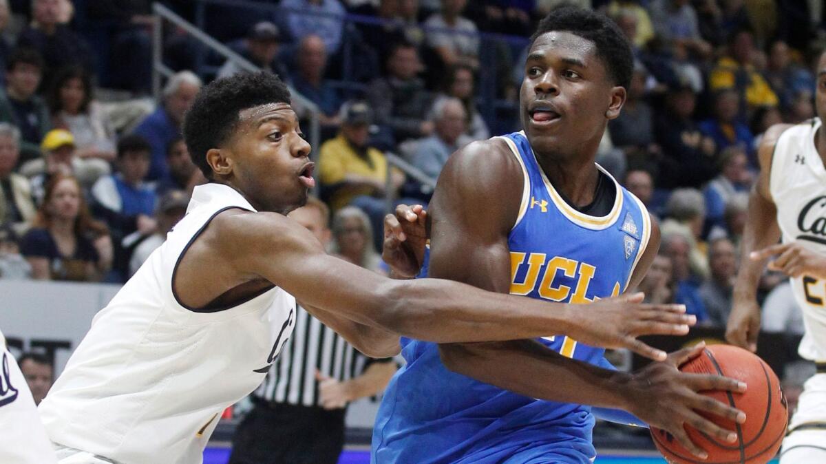 UCLA's Aaron Holiday drives for the basket as California's Darius McNeill defends during the second half.