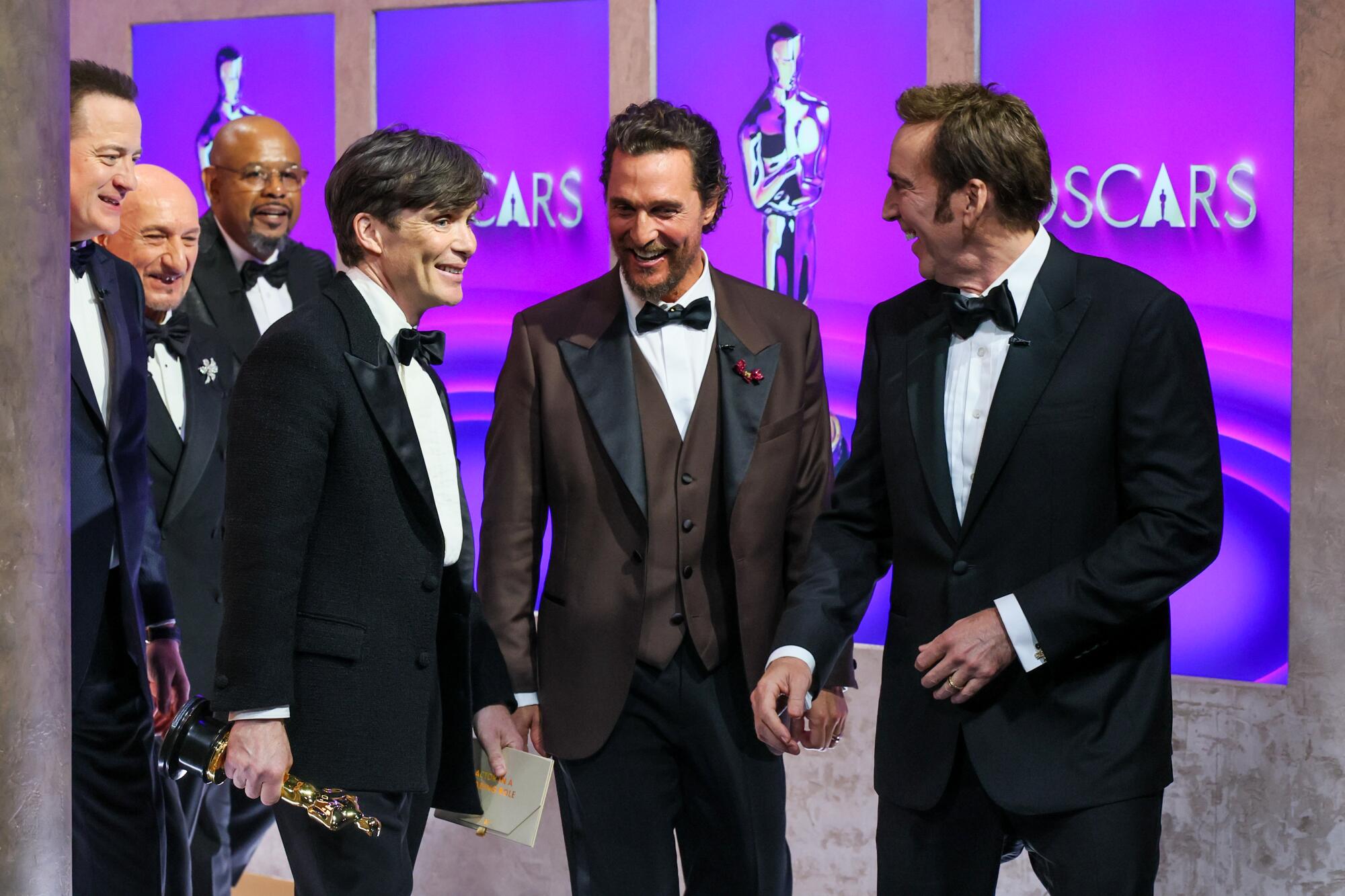 Best Actor winner Cillian Murphy, surrounded by presenters and past winners backstage.