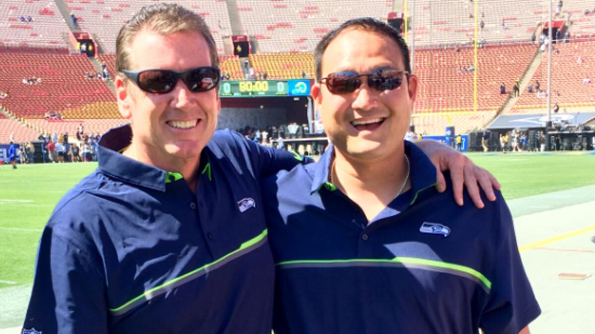 Rick Carr, left, with former USC assistamt coach Rocky Seto, who is now assistant head coach for the Seahawks.