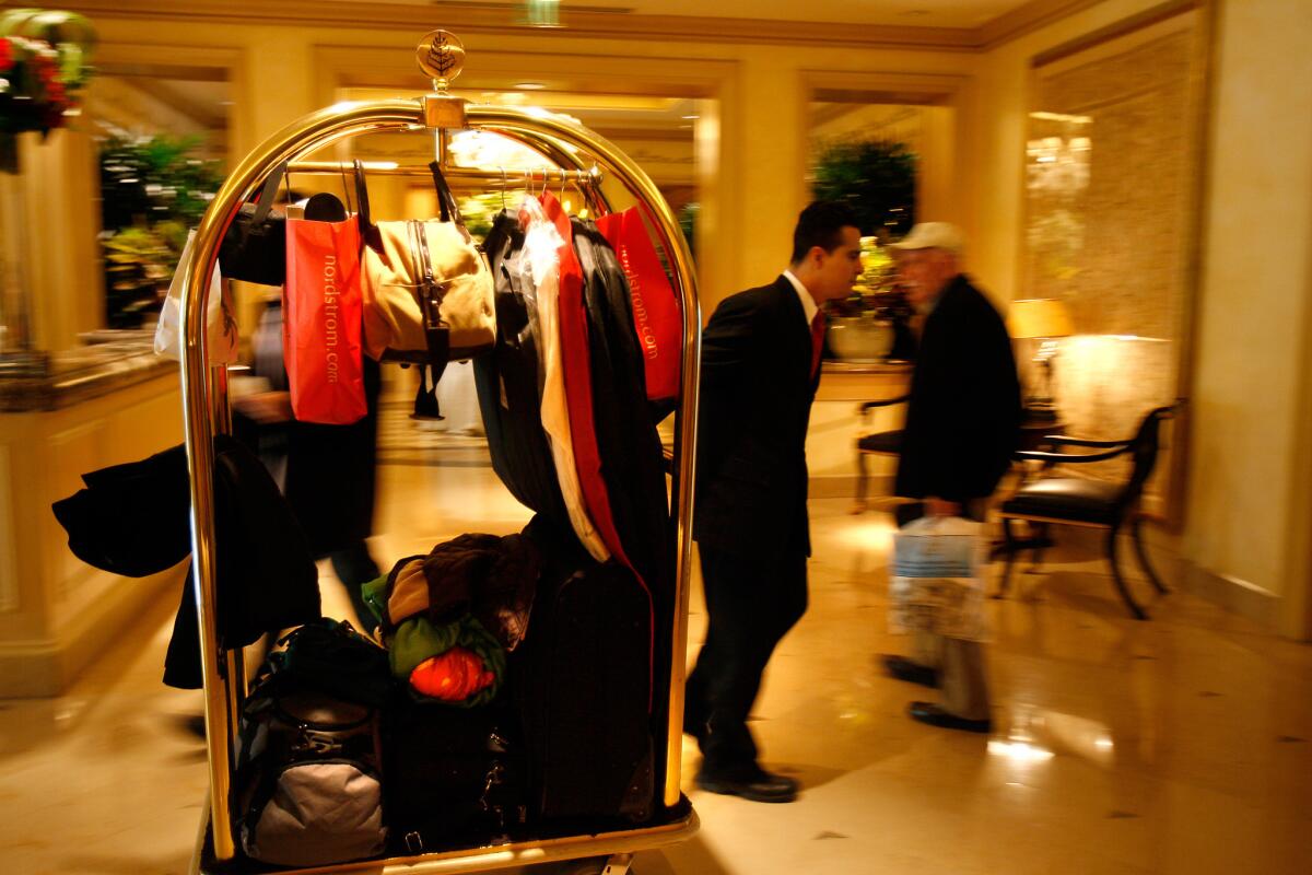 Victor Joya rolls baggage through the lobby of the Four Seasons hotel in Beverly Hills in 2009. Guests who leave their children unsupervised were voted as the biggest etiquette violators at hotels, according to a new survey.