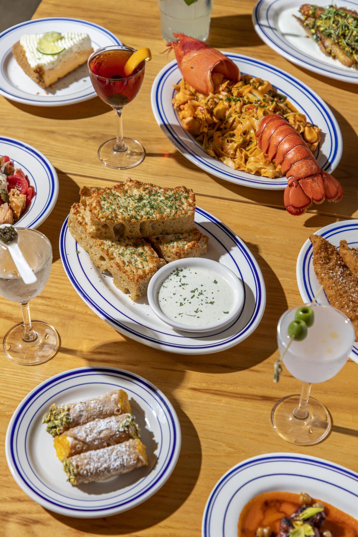 A table with dishes including calamari, martinis and other Italian American fare from Jemma di Mare Brentwood.