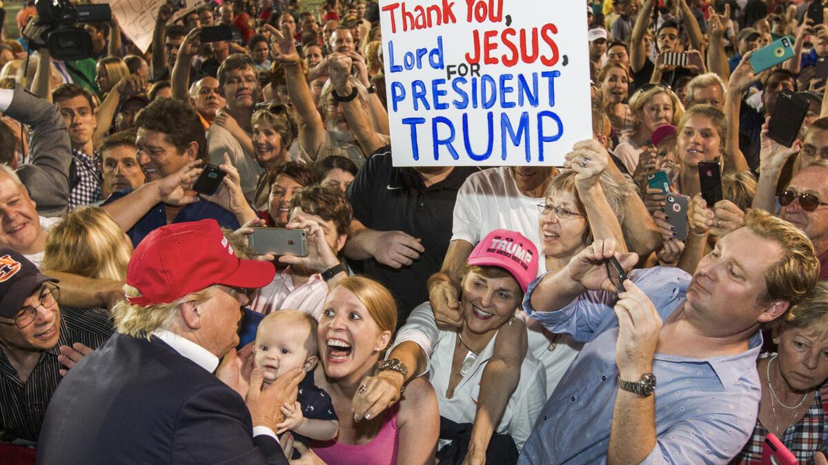 Republican presidential candidate Donald Trump greets supporters after his rally at Ladd-Peebles Stadium on Aug. 21, 2015, in Mobile, Ala.