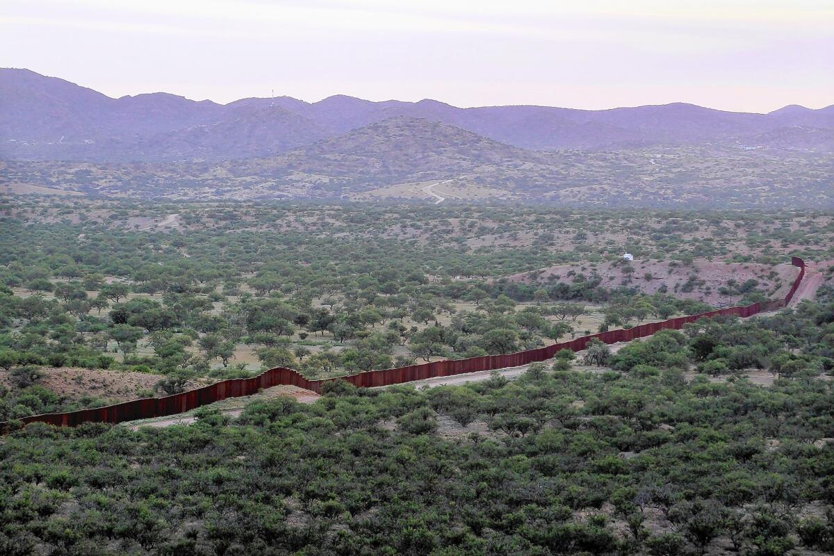 A fence marks the U.S.-Mexico border near Sasabe, Ariz. U.S. officials said Border Patrol agents were fired upon by Mexican law enforcement officers. Mexican authorities disputed that version of events.