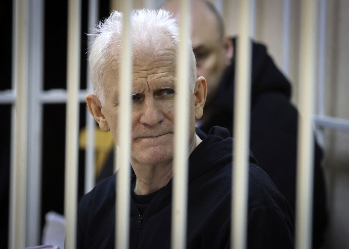 Ales Bialiatski looks out from behind bars.