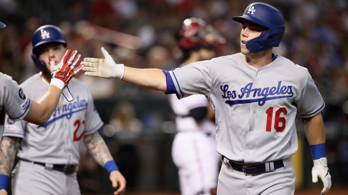 Dodgers catcher Will Smith (16) high fives teammates after hitting a two-run home run against the Arizona Diamondbacks during the third inning on Wednesday in Phoenix.
