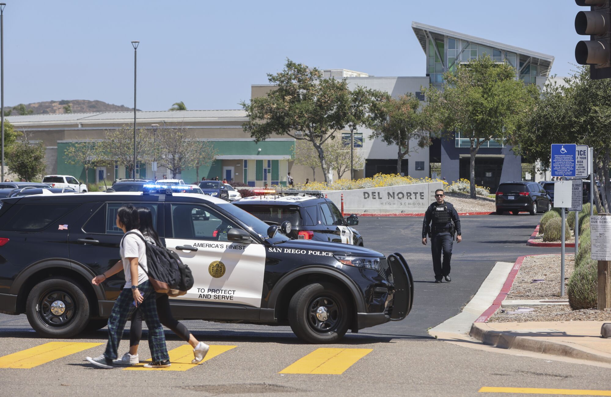 San Diego Police Department officers block the front of Del Norte High School during a lockdown.
