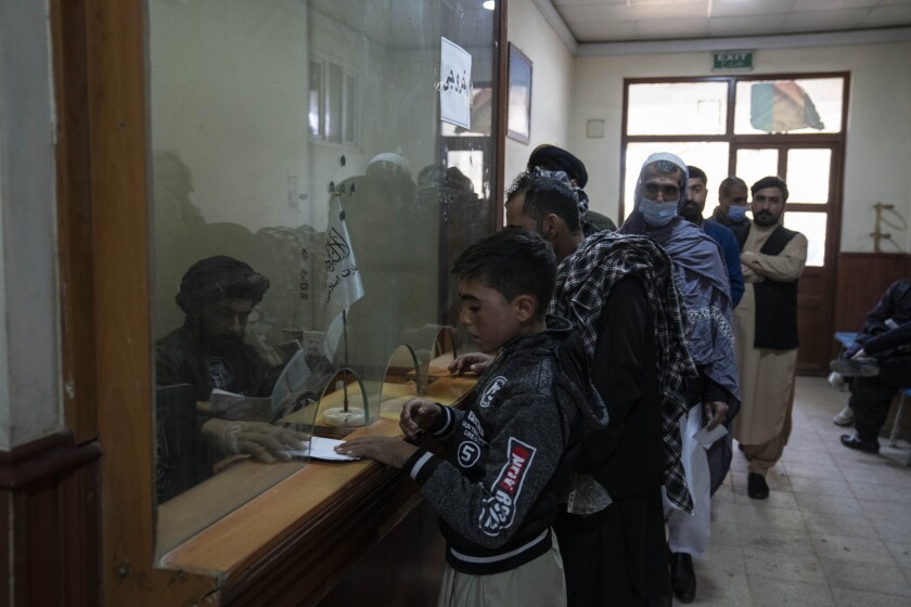 A Taliban official checks passports.