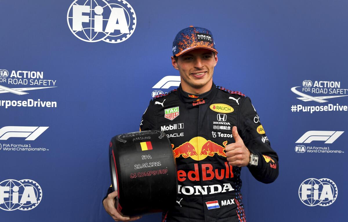 First place for pole position Red Bull driver Max Verstappen of the Netherlands holds the prize after qualification ahead of the Formula One Grand Prix at the Spa-Francorchamps racetrack in Spa, Belgium, Saturday, Aug. 28, 2021. The Belgian Formula One Grand Prix will take place on Sunday. (John Thys, Pool Photo via AP)