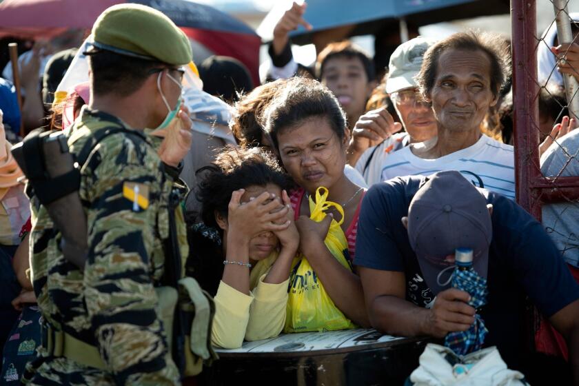 Residents wait to be evacuated at the airport in Tacloban, Philippines, which was devastated by Typhoon Haiyan.