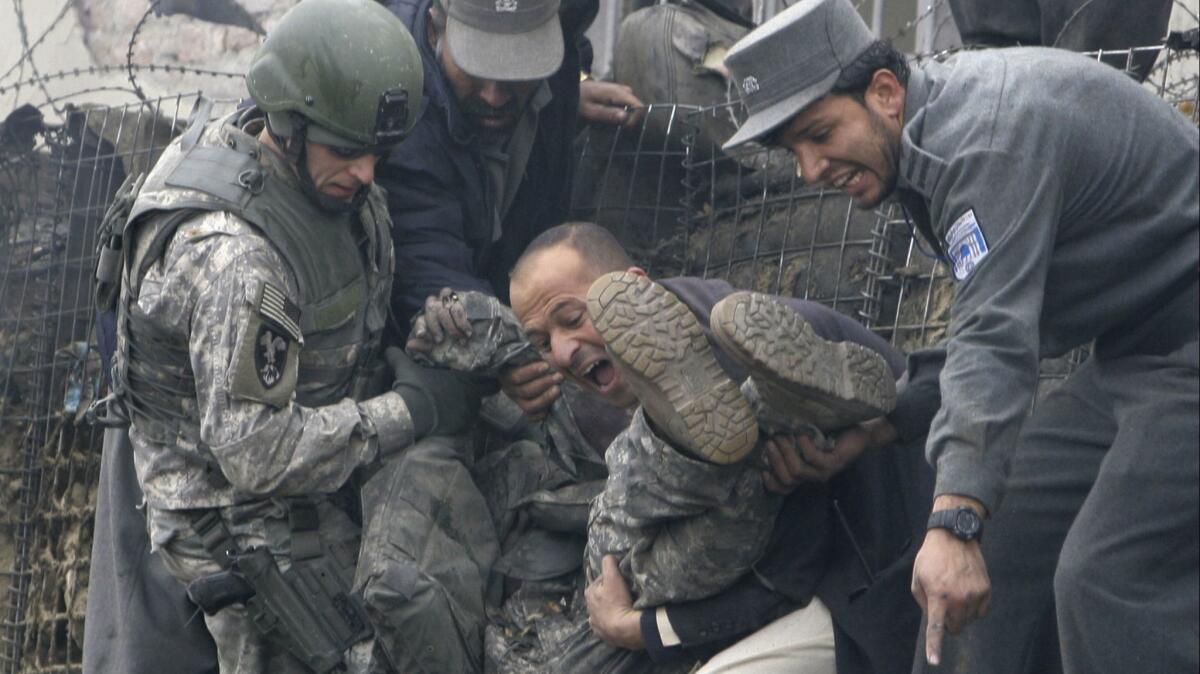 An injured U.S. soldier is helped getting out following a blast in Kabul, Afghanistan, Jan. 17, 2009.