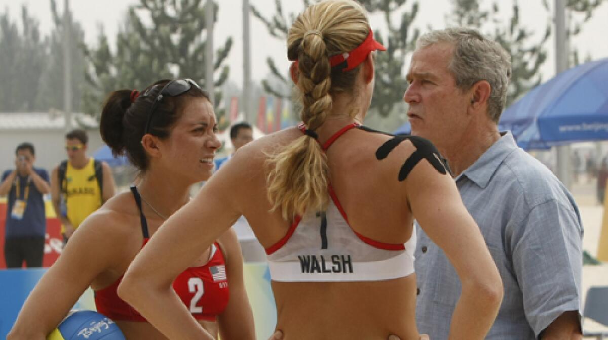 SAND MAN: A shirt-sleeved President Bush gives volleyballers Misty May-Treanor and Kerri Walsh some props.