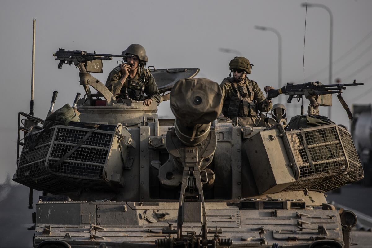 Israeli soldiers and tanks near the Gaza border