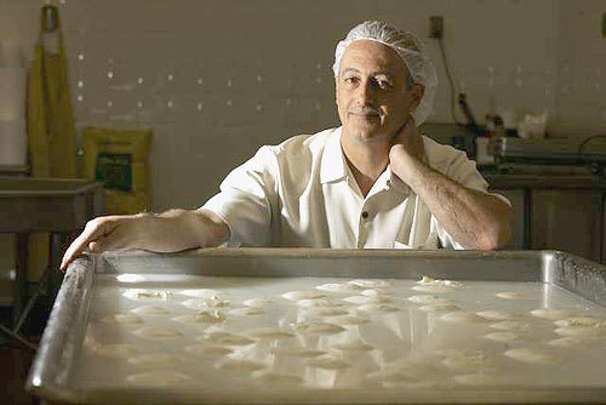 CHEESE MASTER: Vito Girardi with burrata at his Gioia Cheese Co. in South El Monte.