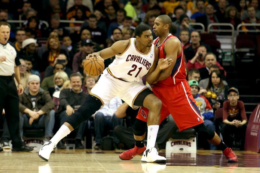 Cavaliers center Andrew Bynum works in the post against Hawks center Al Horford during a game Thursday in Cleveland.