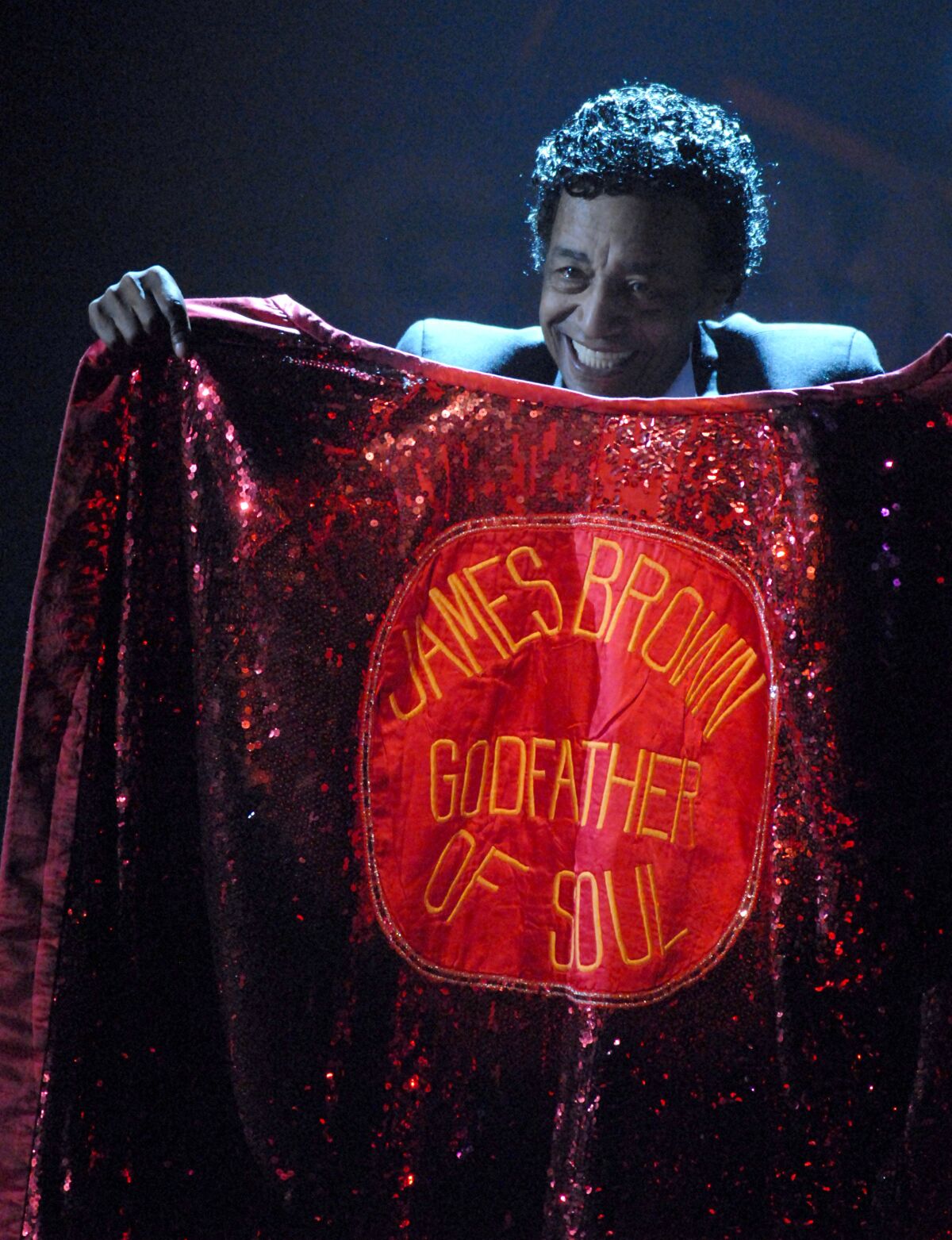 Danny Ray holds the late James Brown's cape at the Grammy Awards in February 2007.