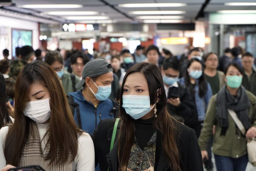 Pasajeros en una estación del metro de Hong Kong lucen máscaras para prevenir contagio en medio de un brote de coronavirus en China.