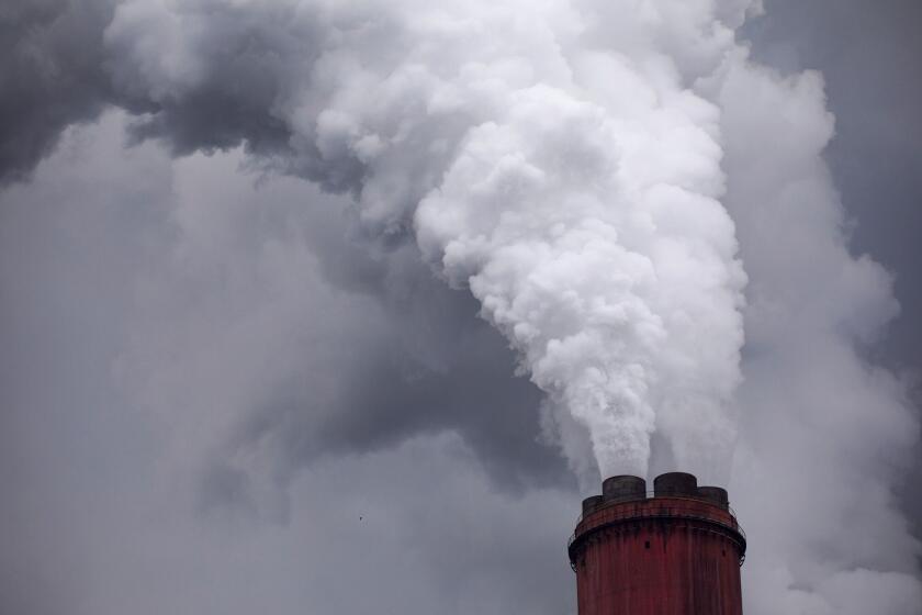 Vapor rises from a chimney at a coal powered power plant. Photographer: Bloomberg Creative Photos/Bloomberg Creative Collection