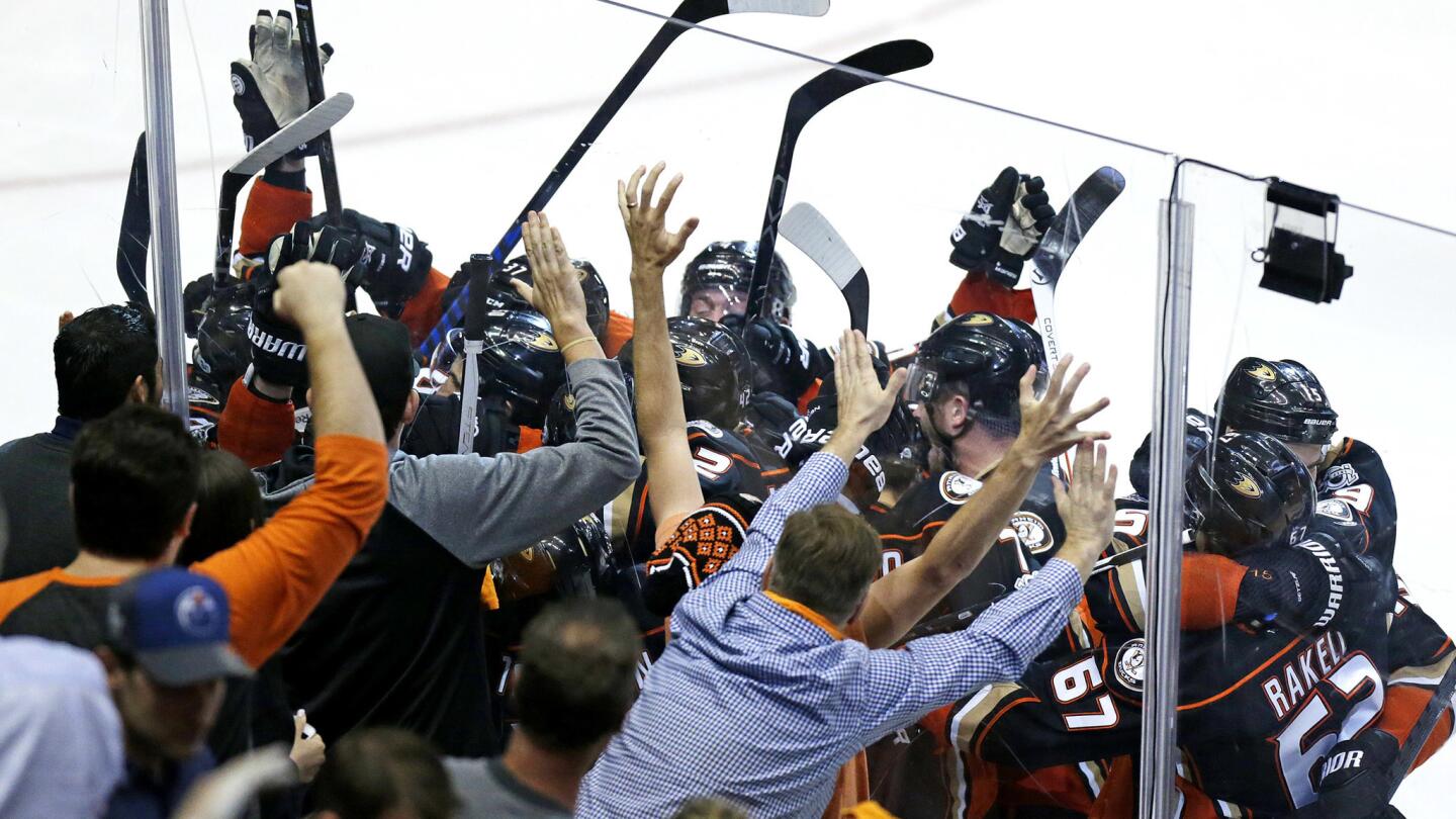 Fans and Ducks players celebrate after Corey Perry (10) scored the game-winning goal in double overtime against the Oilers.