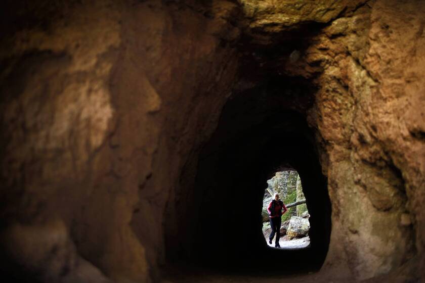 Bernadette Carter, 49, of Hollister, Calif., walks through a man-made tunnel at the new Pinnacles National Park. Officials of the nearby town of Soledad, which sits outside the park's west entrance, hope park tourists will also come their way.