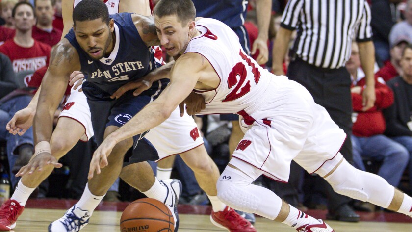 D.J. Newbill of Penn State and Josh Gasser of Wisconsin battle for a loose ball during a Big 10 game on Dec. 31, 2014.