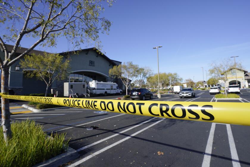 San Diego, CA - December 08: Police tape surrounds the area where a San Diego police sergeant was shot in the head and the suspected gunman was killed after a confrontation with officers in a 4S Ranch shopping center parking lot late Thursday. (Nelvin C. Cepeda / The San Diego Union-Tribune)